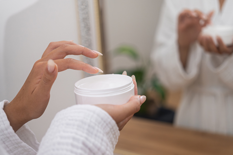 Woman trying lotion in spa